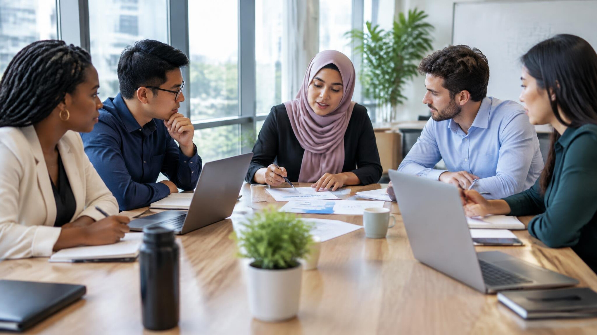 Colleagues in a focused meeting at a table